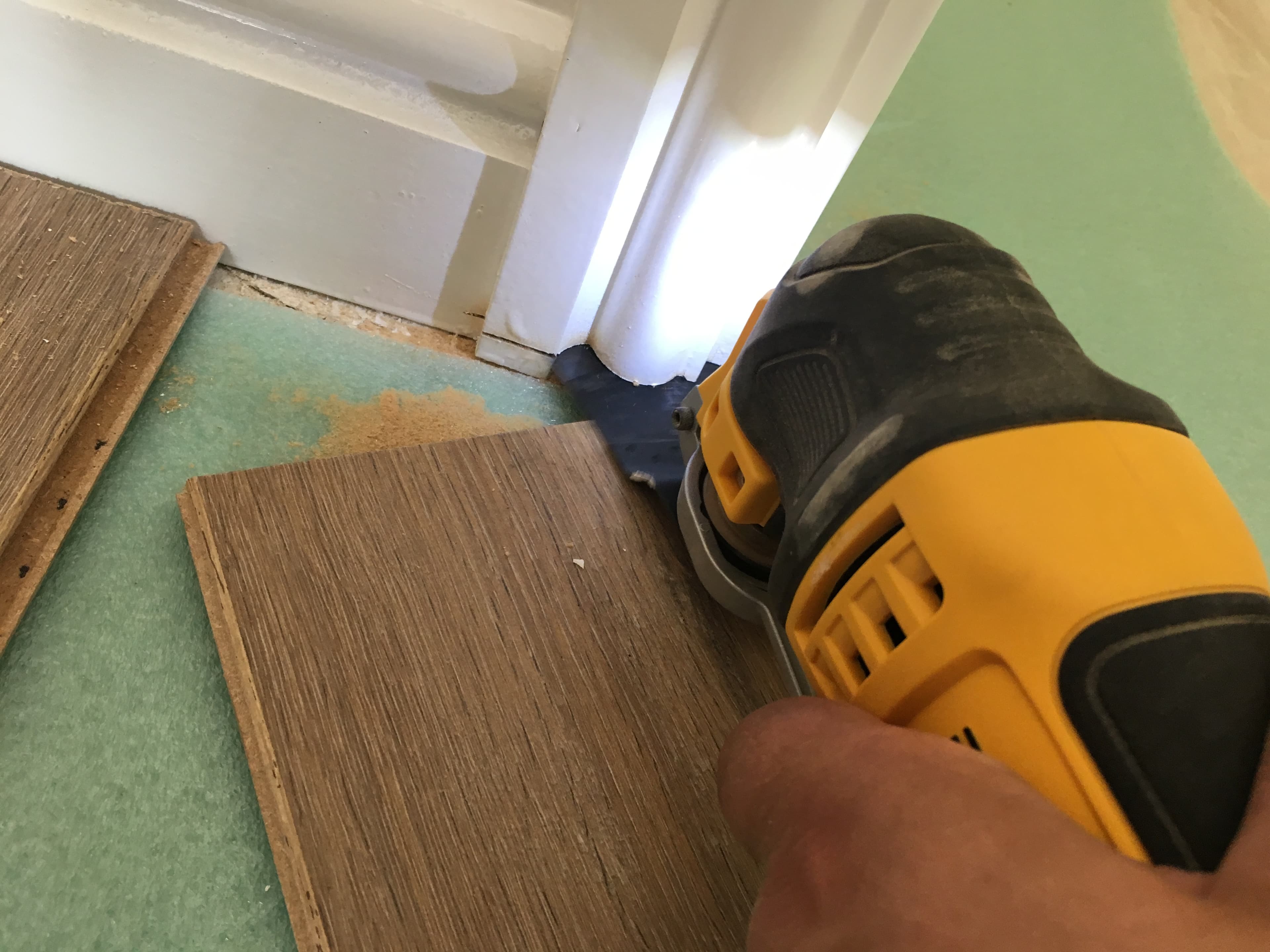Undercutting a door frame so the flooring can slide underneath