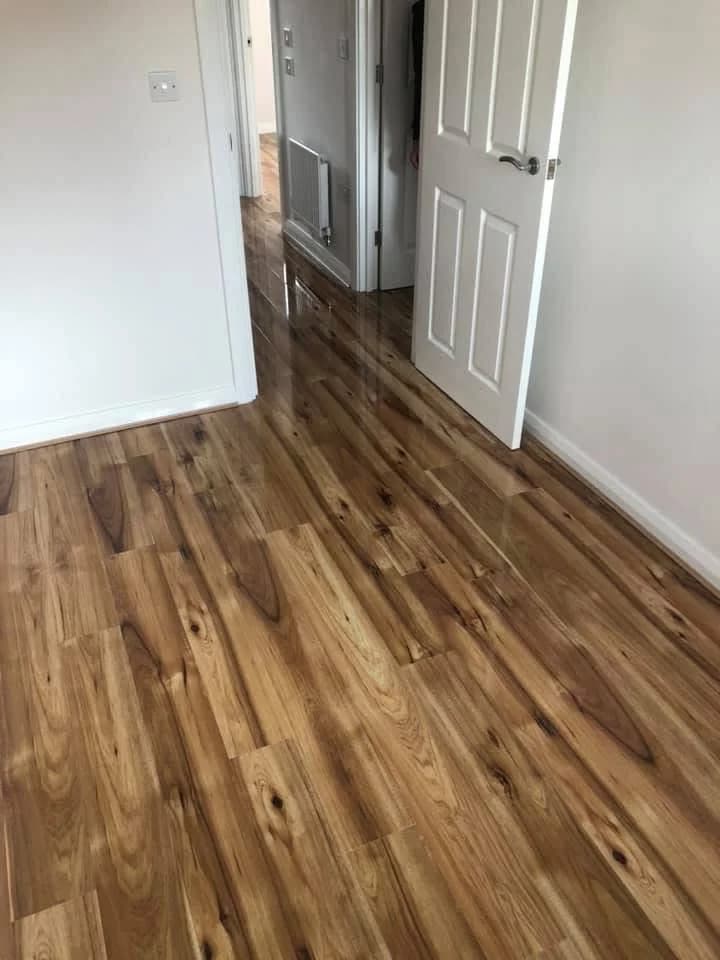 High gloss laminate carried from a room through to the hallway beyond