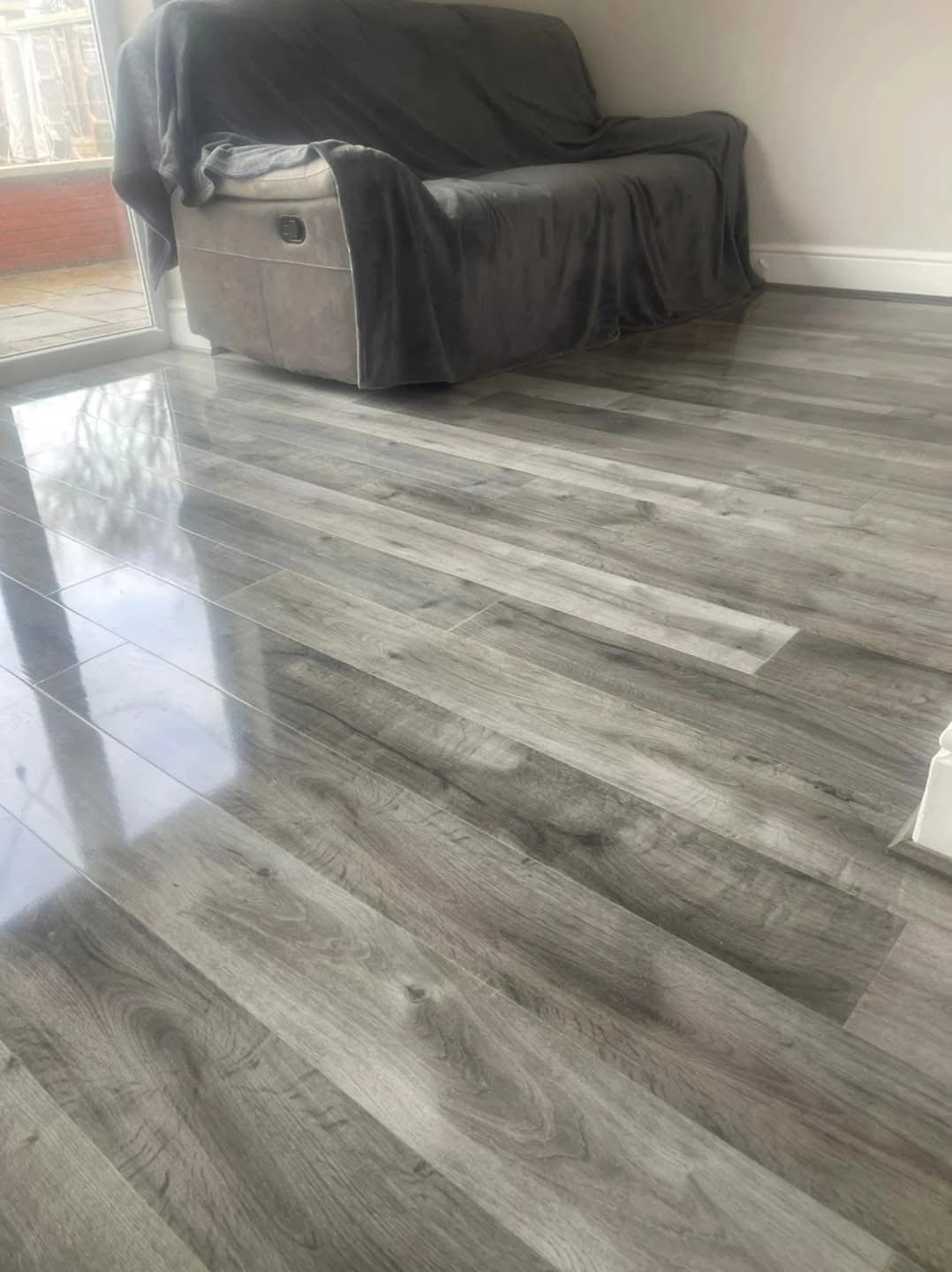 Grey high gloss laminate in a lounge, reflecting the patio doors