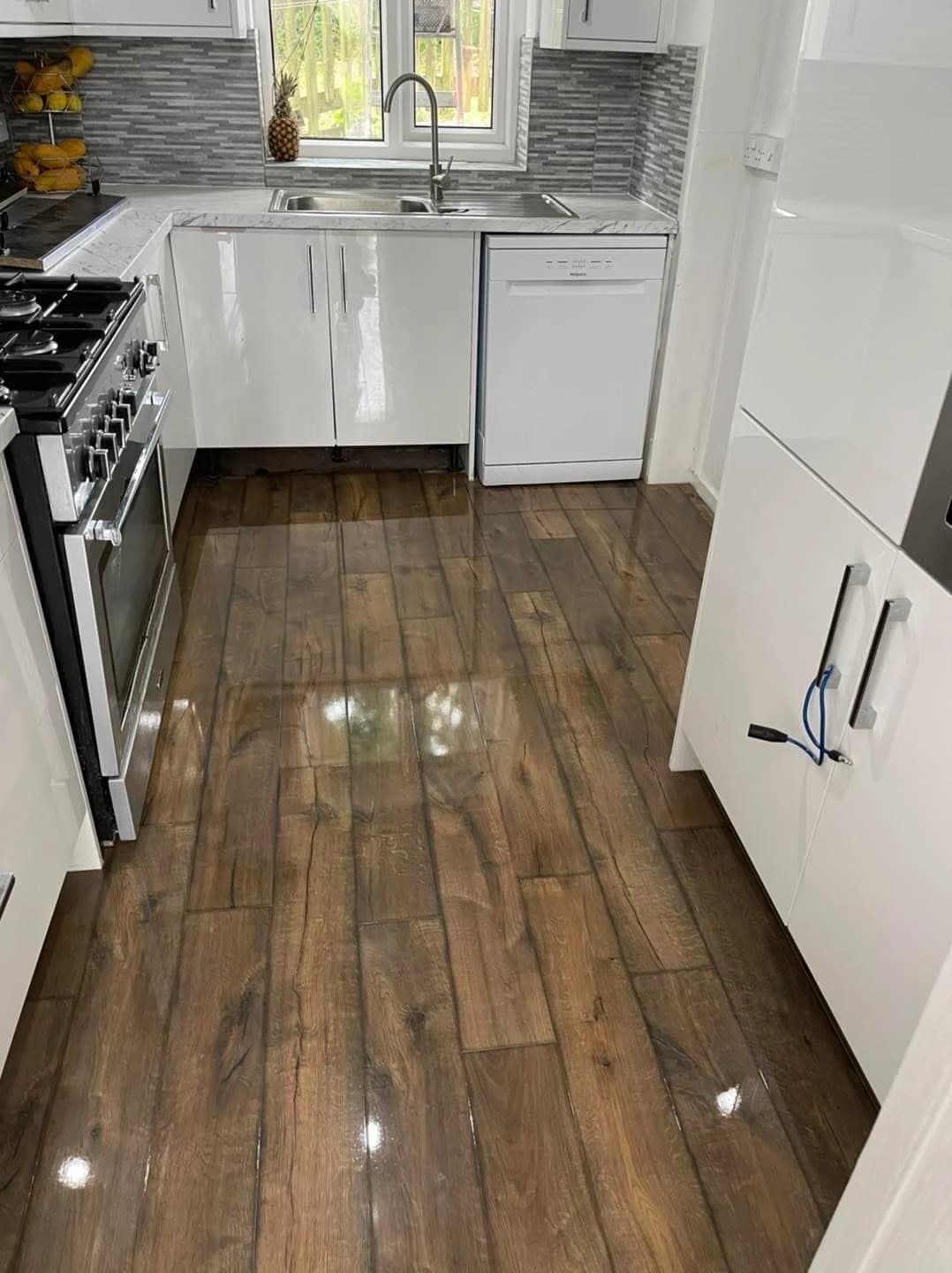 Dark rustic oak high gloss laminate fitted through a white kitchen