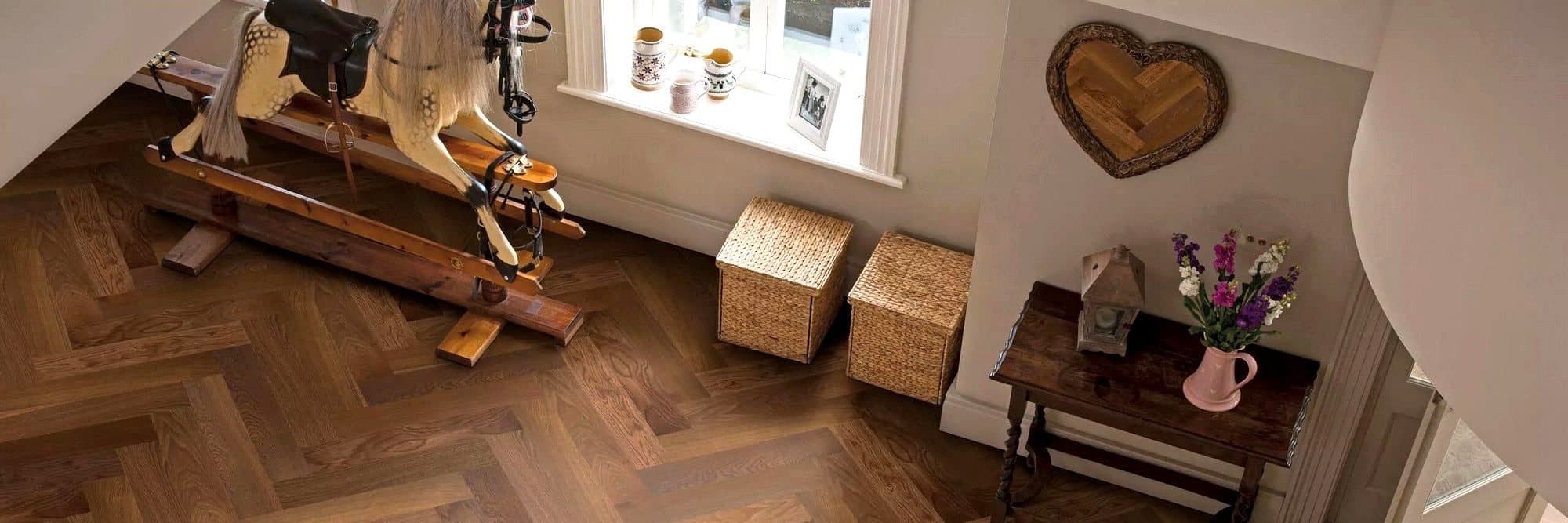 Herringbone wood flooring laid through a hallway
