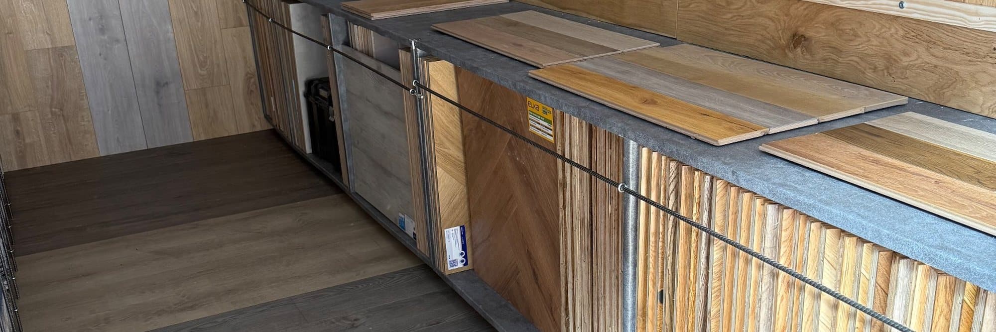 Flooring sample boards and racks inside the Floor Fitter Wales mobile showroom