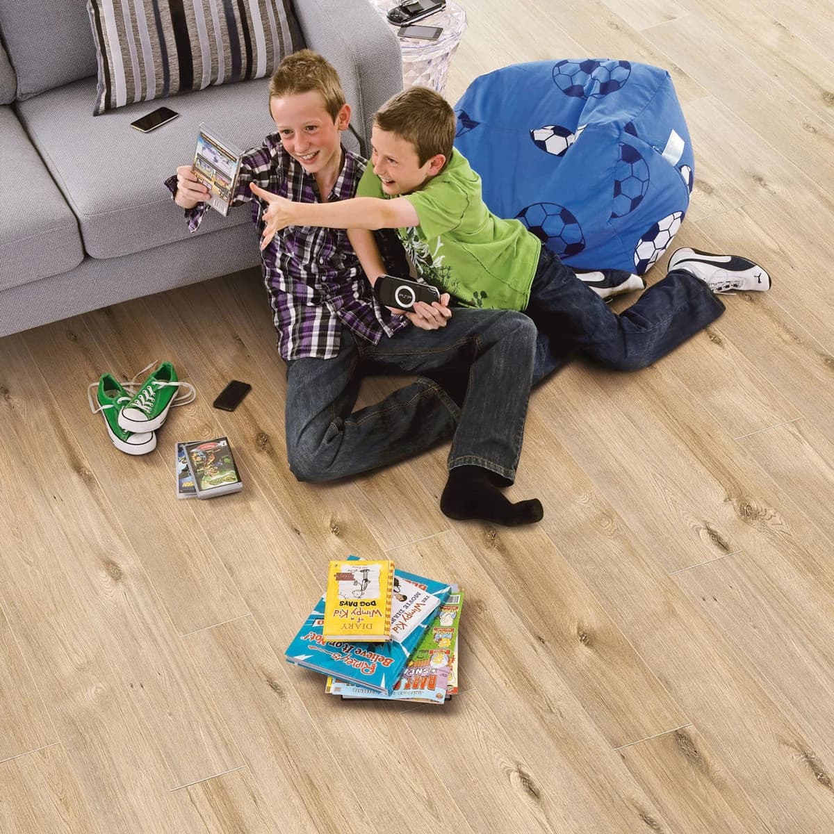 Light oak laminate flooring in a living room with two children sitting reading