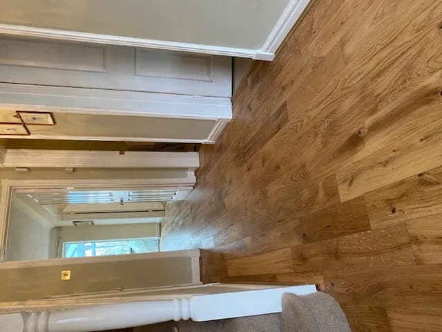 Engineered oak flooring running through a hallway and on through two open doorways
