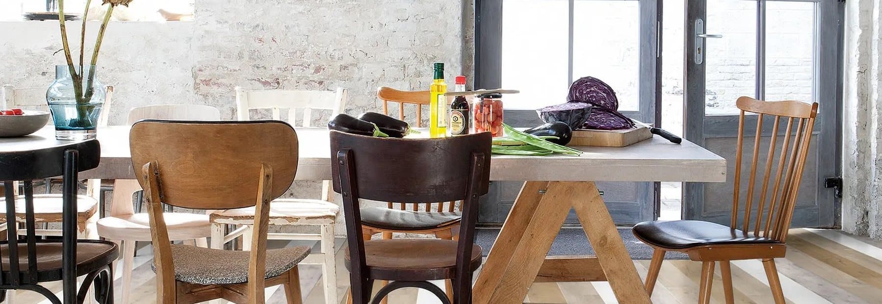 A wide-plank oak floor running through an open-plan kitchen and dining room