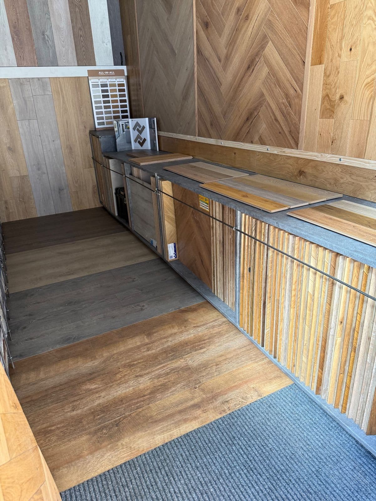 Inside the Floor Fitter Wales mobile showroom, fitted out with laminate, wood and vinyl displays